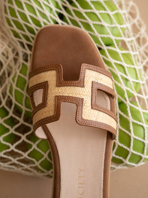 The Ena Brown H Cutout Raffia Slide Sandal