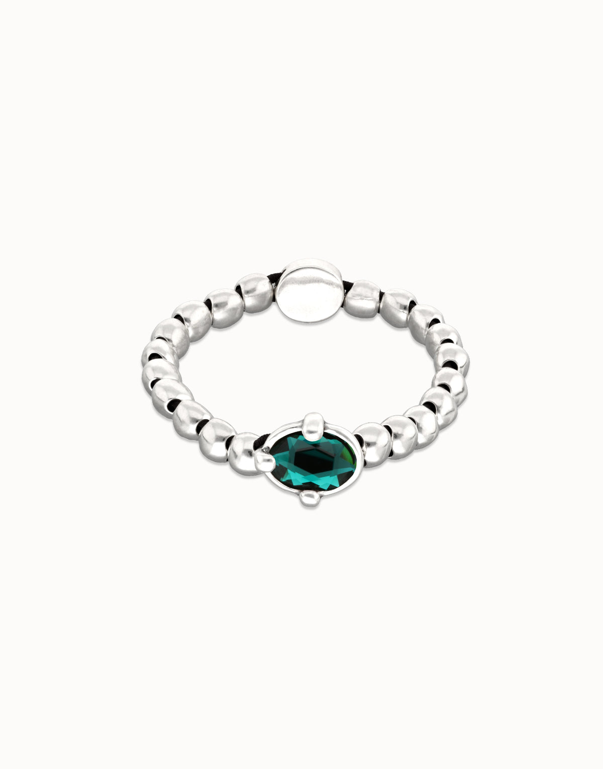 Silver bracelet with a green gemstone on a white background
